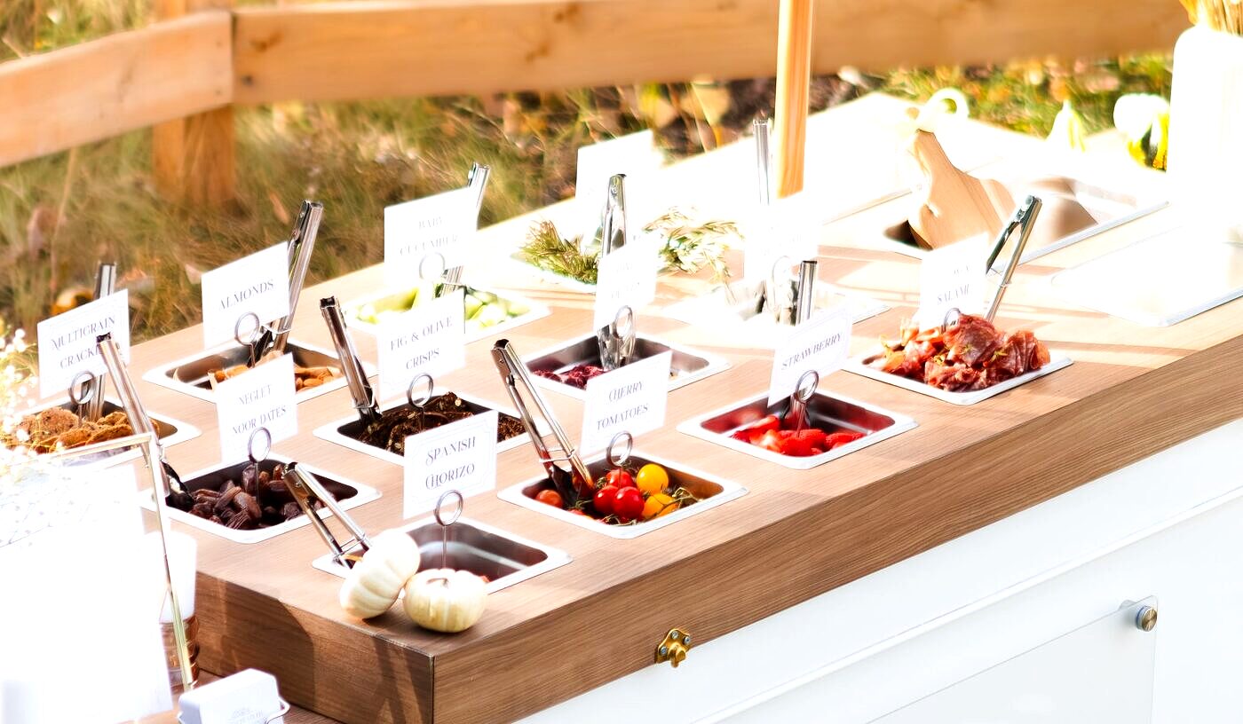 Front view of the Cured Creations charcuterie cart fully styled at an outdoor Edmonton event