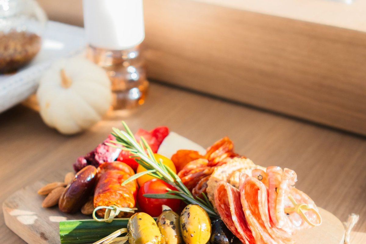 Spring garden gathering charcuterie board with edible flowers and seasonal fruit