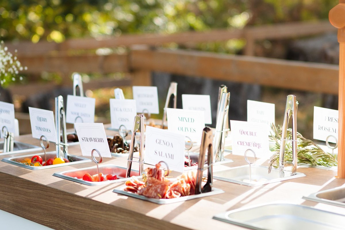 Styled summer wedding charcuterie station at an Edmonton-area outdoor reception