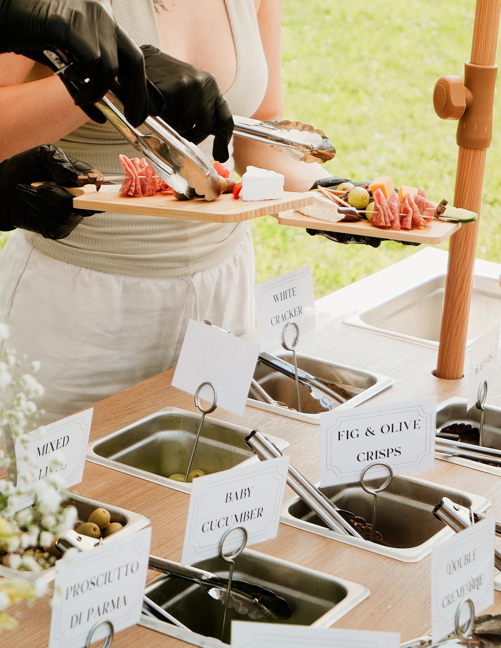 An individual charcuterie board being prepared at the cart